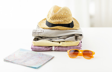 Image showing close up of summer clothes and travel map on table