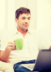 Image showing man working with laptop at home