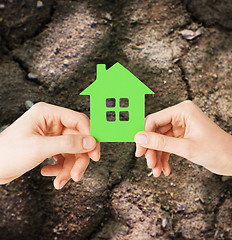 Image showing close up of couple hands holding green house