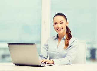 Image showing businesswoman with laptop in office