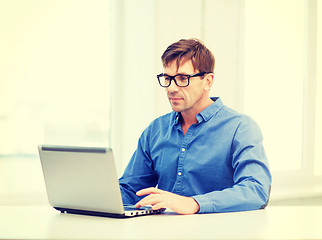 Image showing man working with laptop at home