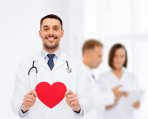 Image showing smiling male doctor with red heart