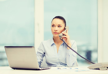 Image showing businesswoman with phone, laptop and files