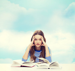 Image showing stressed student girl with books