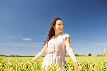 Image showing smiling young woman on cereal field