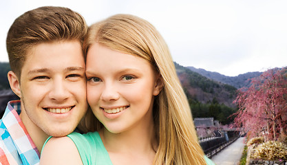 Image showing smiling couple over asian landscape background