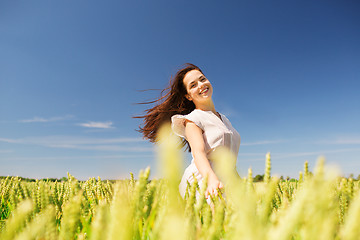 Image showing smiling young woman on cereal field