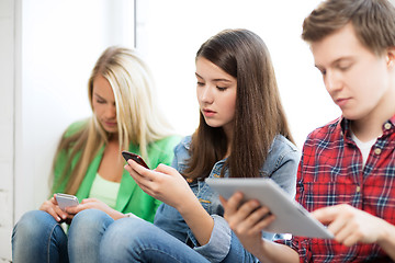 Image showing students looking into devices at school