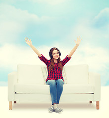 Image showing teenage girl sitting on sofa with headphones