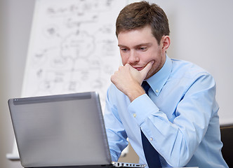 Image showing businessman sitting with laptop in office