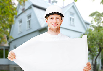 Image showing male builder or architect in helmet with blueprint