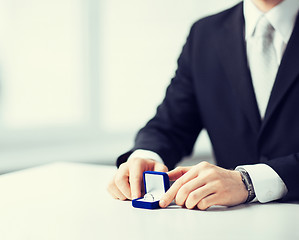 Image showing man with gift box and wedding ring