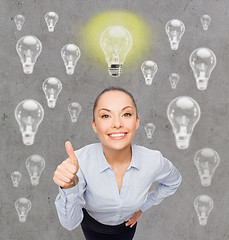 Image showing smiling young woman in eyeglasses having idea