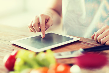 Image showing closeup of man pointing finger to tablet pc