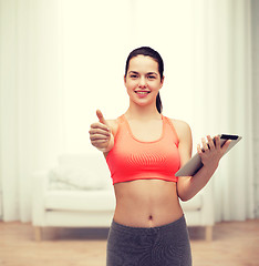 Image showing sporty woman with tablet pc computer