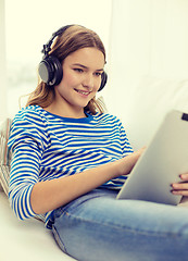 Image showing girl with tablet pc and headphones at home