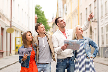 Image showing group of smiling friends with city guide and map