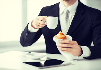 Image showing man with tablet pc and cup of coffee