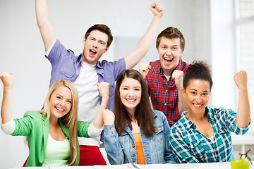 Image showing students holding hands up at school