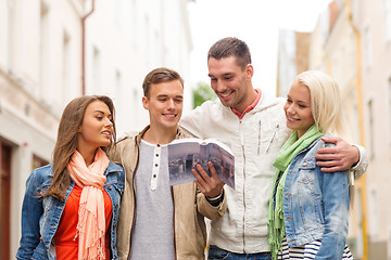 Image showing group of friends with city guide exploring town