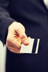 Image showing man in suit holding credit card