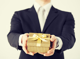 Image showing man hands holding gift box