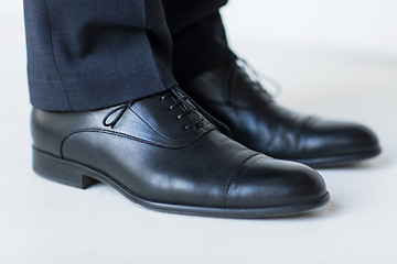 Image showing close up of man legs in elegant shoes with laces