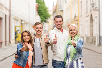 Image showing group of smiling friends showing thumbs up