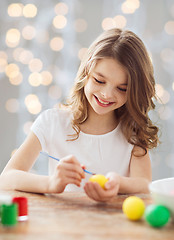 Image showing close up of girl with brush coloring easter eggs