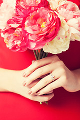 Image showing woman hands with flowers and ring