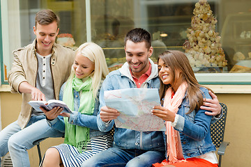 Image showing group of friends with guide and map exploring town