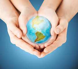 Image showing close up of woman and man hands with earth globe