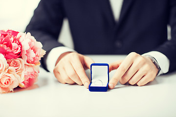 Image showing man with gift box and wedding ring