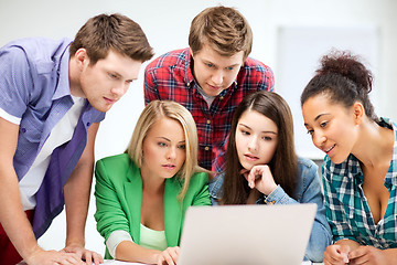 Image showing international students looking at laptop at school