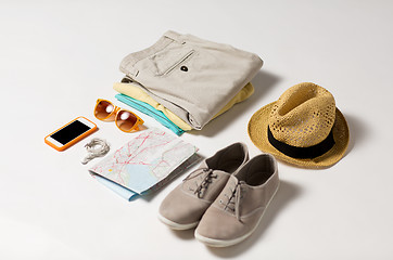 Image showing close up of summer clothes and travel map on table