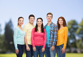 Image showing group of smiling teenagers over green park