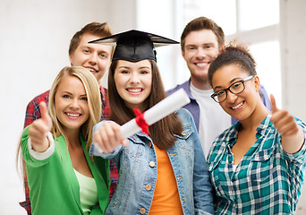 Image showing student girl in graduation cap with diploma