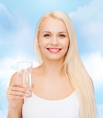 Image showing young smiling woman with glass of water