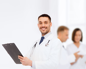 Image showing smiling male doctor with clipboard and stethoscope