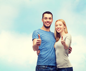 Image showing smiling couple showing thumbs up