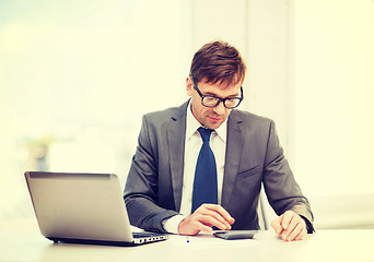 Image showing businessman with computer, papers and calculator