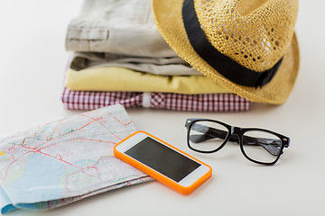 Image showing close up of summer clothes and travel map on table