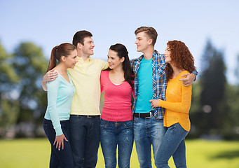 Image showing group of smiling teenagers over green park