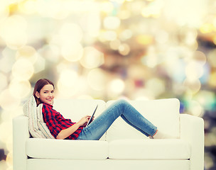 Image showing teenage girl sitting on sofa with tablet pc