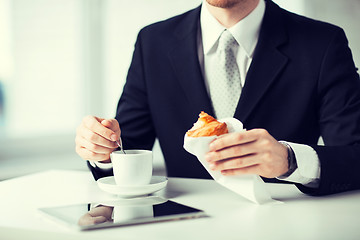 Image showing man with tablet pc and cup of coffee