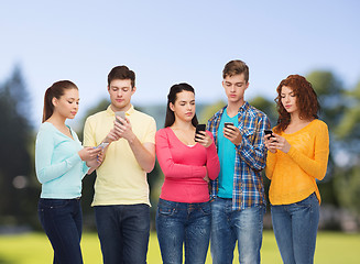 Image showing group of serious teenagers with smartphones