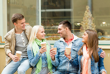 Image showing group of smiling friends with take away coffee