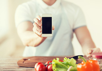 Image showing close up of male hands holding smartphone