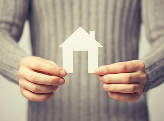 Image showing man holding paper house