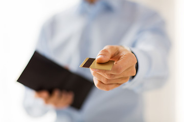 Image showing close up of man holding wallet and credit card